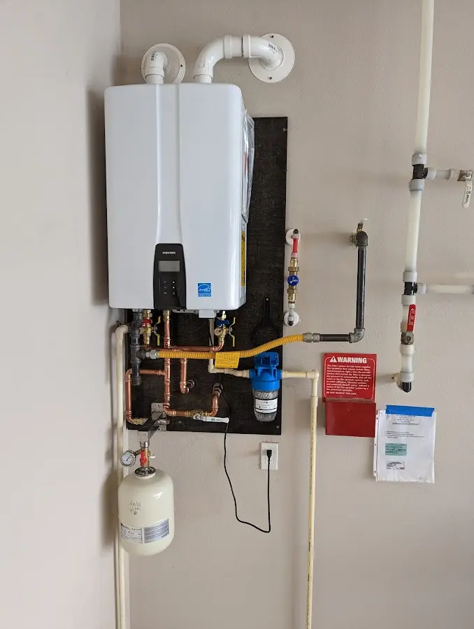 Professional plumber installing copper piping in a Park home